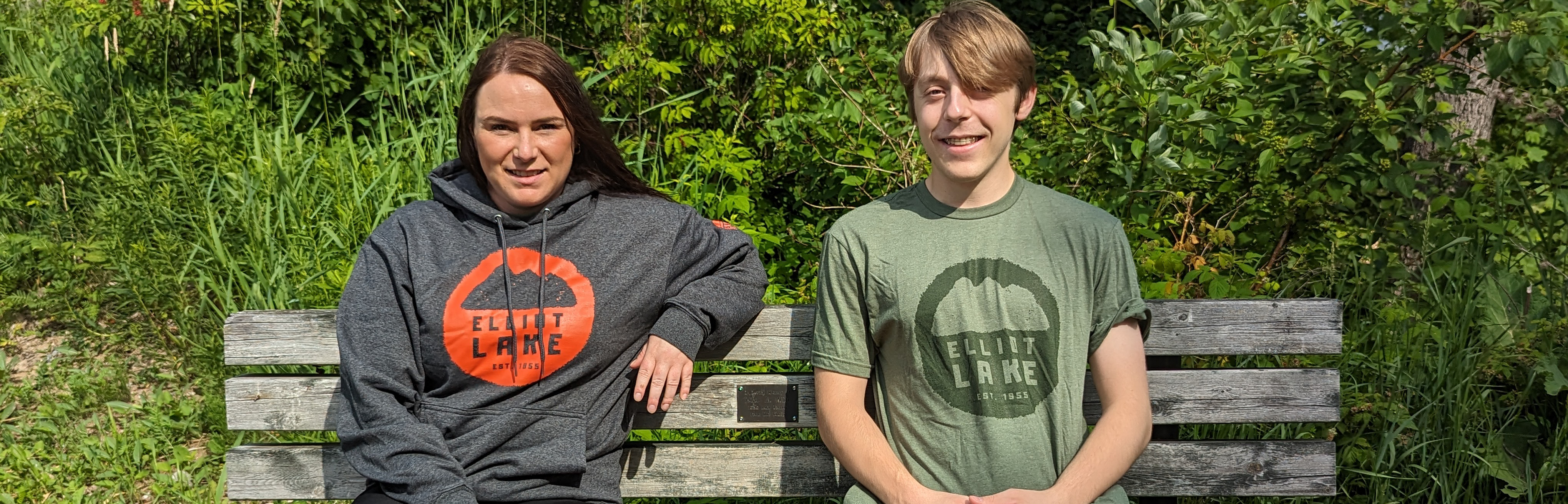 man and woman on bench wearing elliot lake shirts
